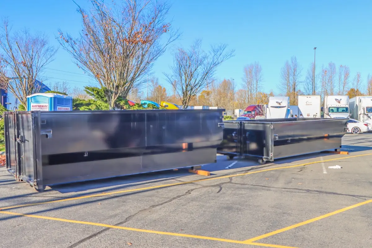 Professional dumpster rental service with roll-off container on residential driveway in Steele Creek